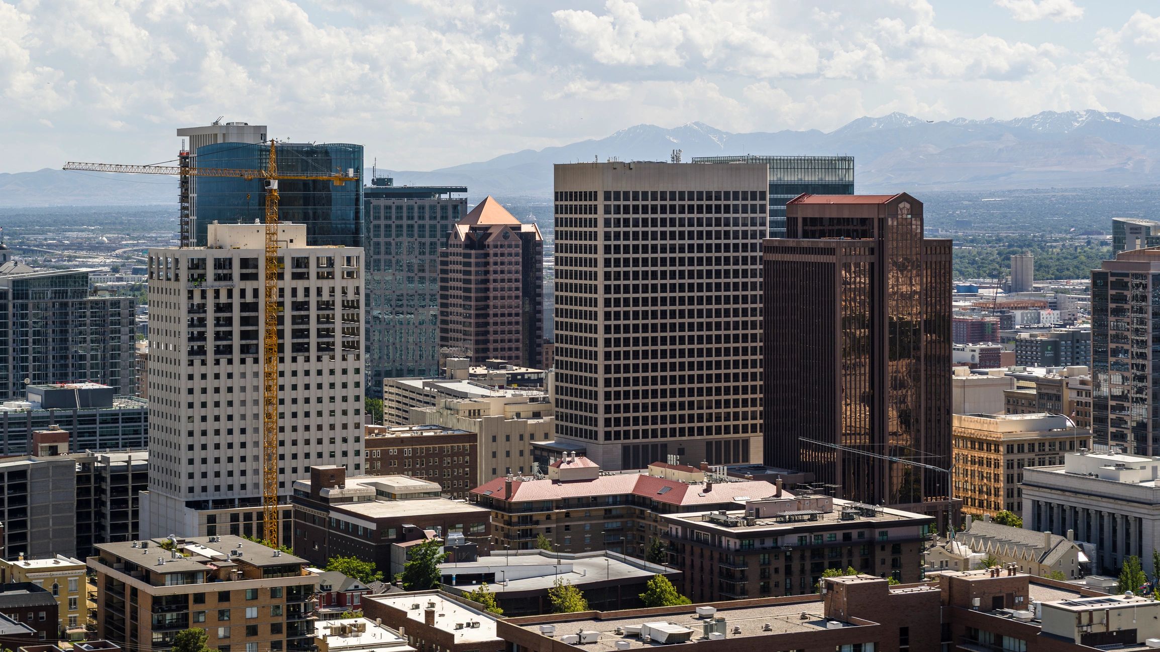 Modern architecture in Salt Lake City, Utah. Office buildings and construction with Wasatch mountains in background.